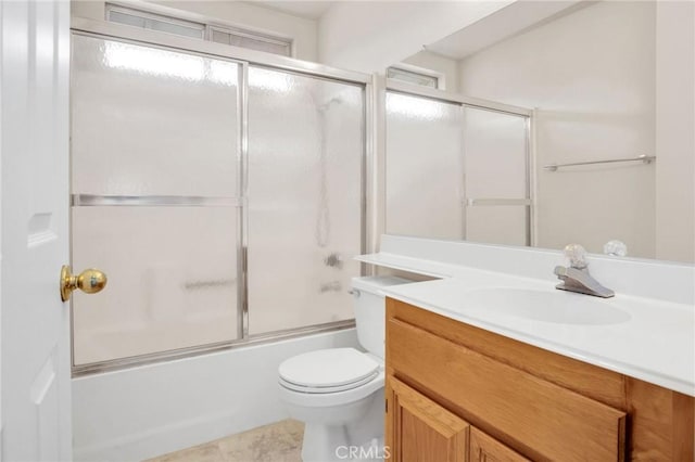 full bath featuring shower / bath combination with glass door, toilet, and vanity