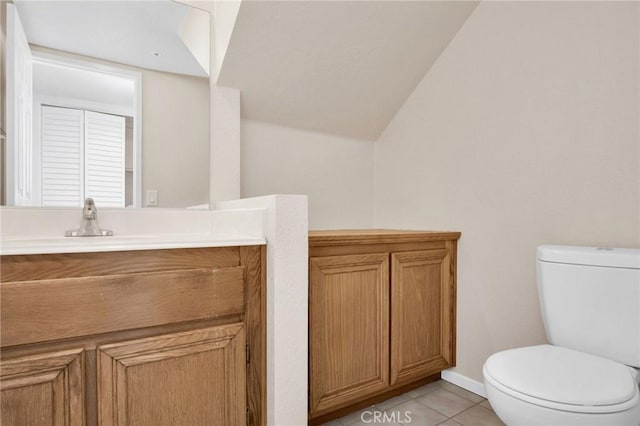 bathroom featuring tile patterned flooring, toilet, vanity, and baseboards