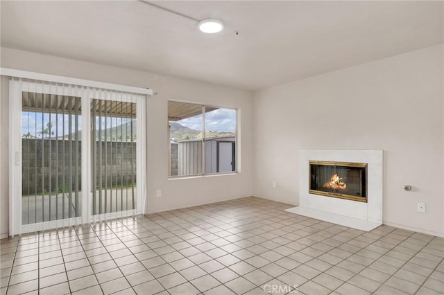 unfurnished living room featuring light tile patterned floors and a fireplace with flush hearth