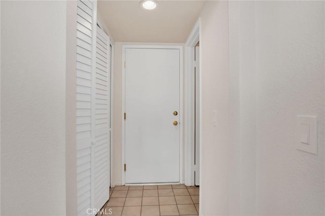 hallway featuring light tile patterned flooring