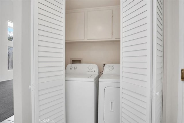 laundry area with cabinet space, washer and dryer, and light carpet