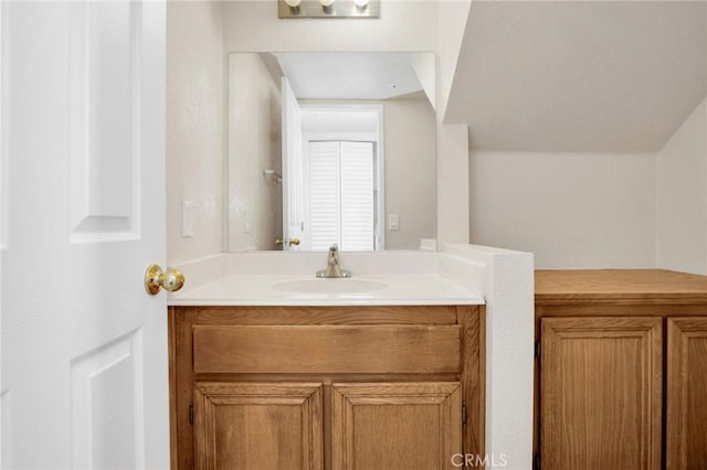 bathroom with vanity and vaulted ceiling