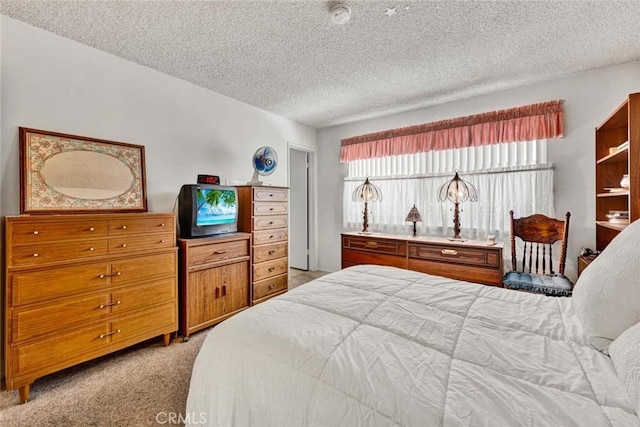 bedroom featuring light colored carpet and a textured ceiling