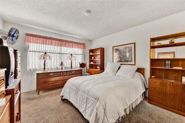 carpeted bedroom featuring a textured ceiling