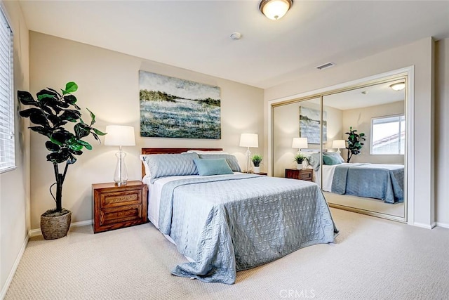 bedroom featuring visible vents, baseboards, and carpet