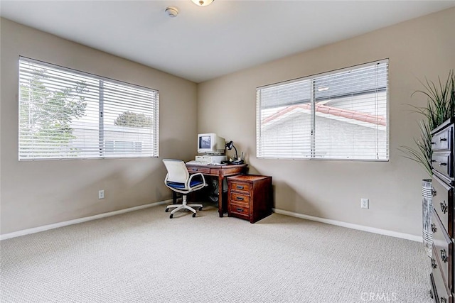 office area featuring baseboards and carpet