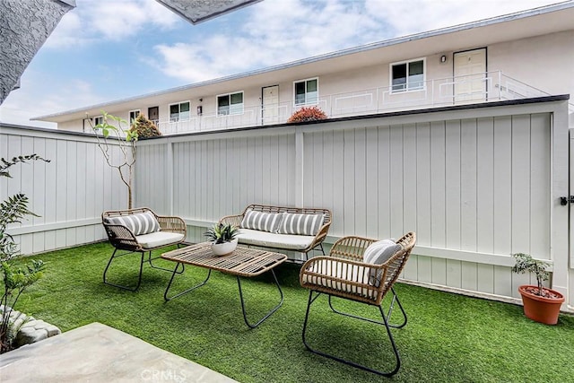 view of patio / terrace featuring outdoor lounge area and fence