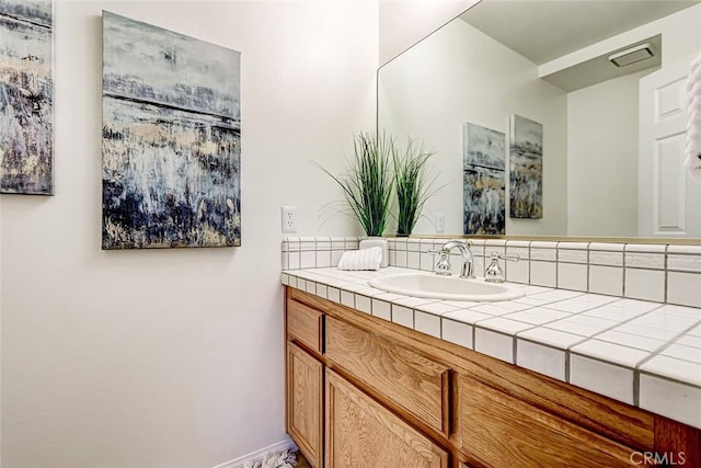 bathroom featuring vanity and baseboards