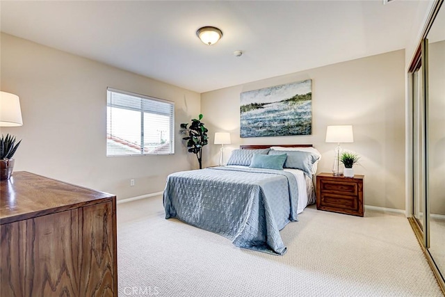 bedroom featuring a closet, baseboards, and carpet