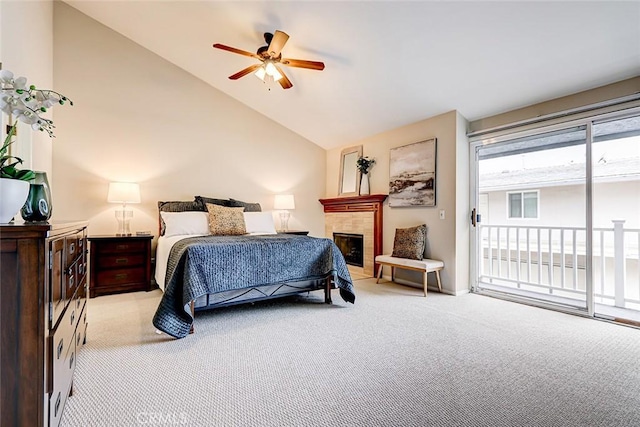 bedroom with high vaulted ceiling, ceiling fan, a tiled fireplace, access to outside, and light colored carpet