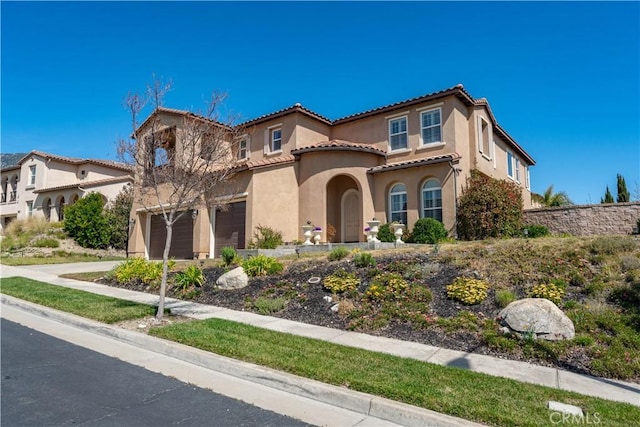 12680 Encino Ct, Rancho Cucamonga, CA 91739 - mediterranean / spanish-style house with a garage, a tiled roof, stucco siding, and driveway