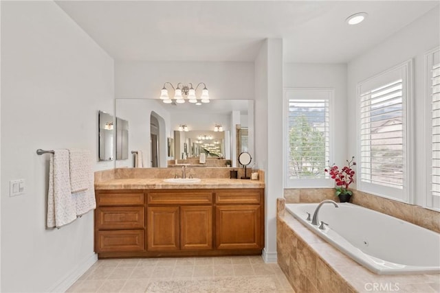 bathroom with tile patterned floors, baseboards, a bath, and vanity