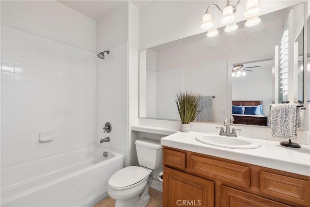 bathroom featuring tile patterned floors, toilet, washtub / shower combination, ceiling fan, and vanity