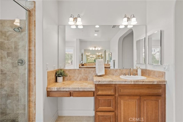 bathroom featuring a stall shower and vanity