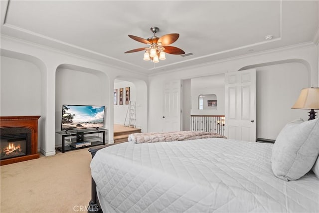 12680 Encino Ct, Rancho Cucamonga, CA 91739 - bedroom featuring ornamental molding, carpet floors, a glass covered fireplace, arched walkways, and ceiling fan