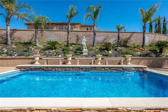 view of swimming pool with a fenced in pool and fence