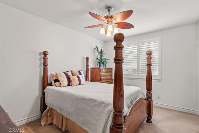 bedroom featuring light carpet, ceiling fan, and baseboards