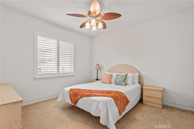 bedroom featuring baseboards, light carpet, and ceiling fan