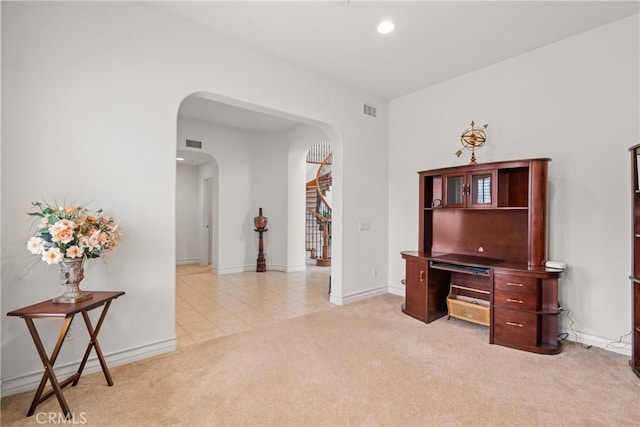 office area with visible vents, recessed lighting, light colored carpet, and arched walkways