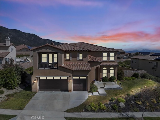12680 Encino Ct, Rancho Cucamonga, CA 91739 - mediterranean / spanish-style house with an attached garage, stucco siding, a tiled roof, concrete driveway, and a mountain view