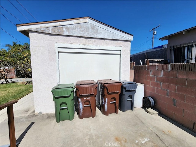 exterior space featuring an outdoor structure and fence