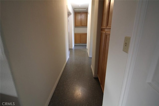 hallway featuring baseboards