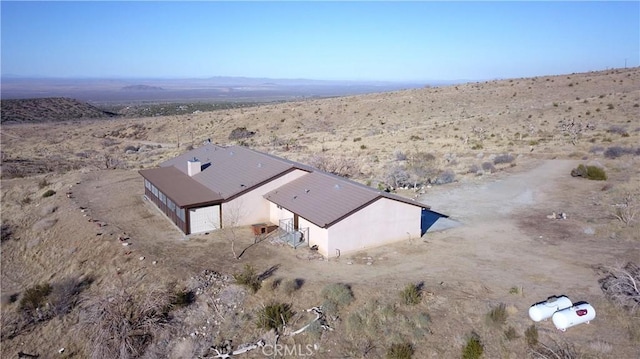 drone / aerial view featuring a desert view