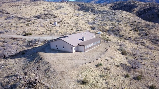 aerial view featuring a mountain view and a desert view