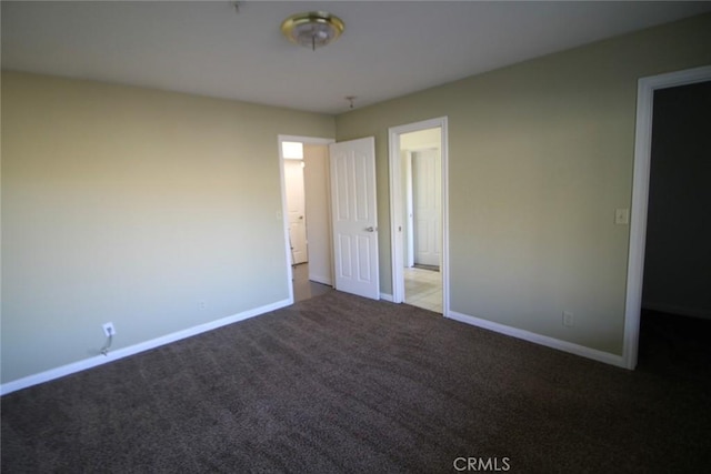 unfurnished bedroom featuring baseboards and carpet floors