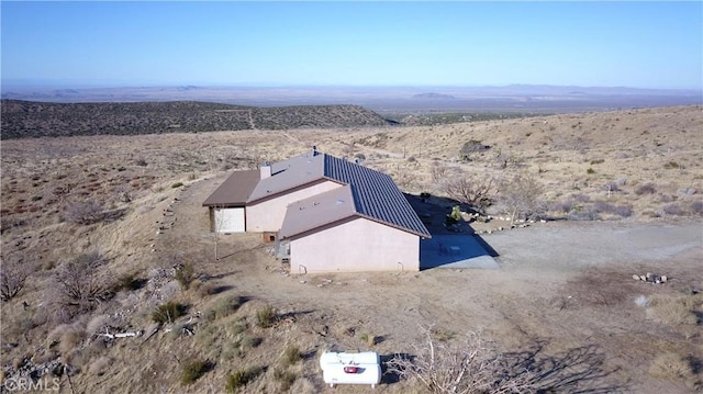 drone / aerial view with view of desert and a mountain view