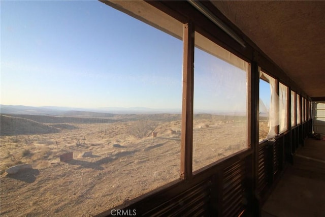 exterior space with a mountain view and a sunroom