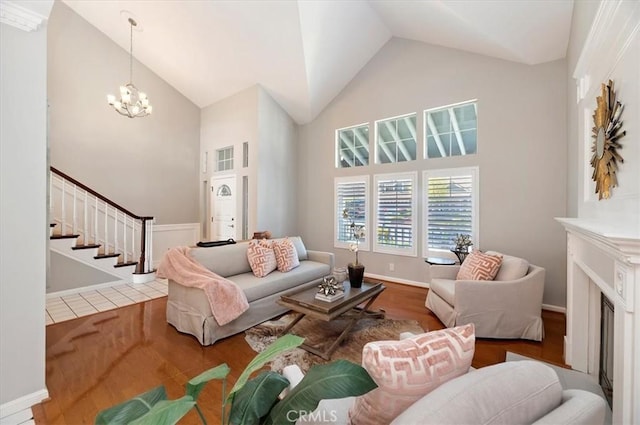 43966 Highlander Dr, Temecula, CA 92592 - living room with wood finished floors, stairs, high vaulted ceiling, and a chandelier