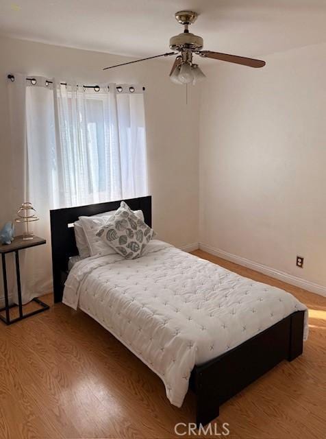 bedroom with light wood-style floors and baseboards