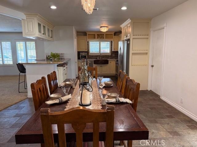 dining area with recessed lighting, stone finish flooring, and baseboards