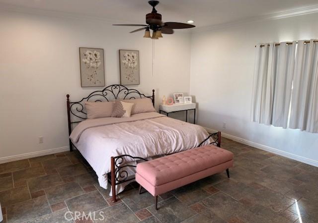 bedroom with baseboards, ornamental molding, recessed lighting, stone finish floor, and a ceiling fan