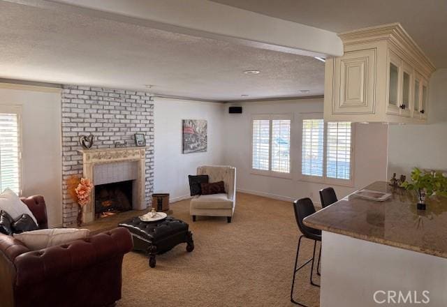 carpeted living room with a fireplace, a textured ceiling, and baseboards