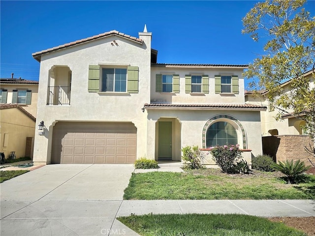 mediterranean / spanish-style house featuring stucco siding, driveway, and a tile roof