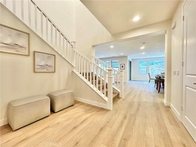 staircase featuring recessed lighting, baseboards, and wood finished floors