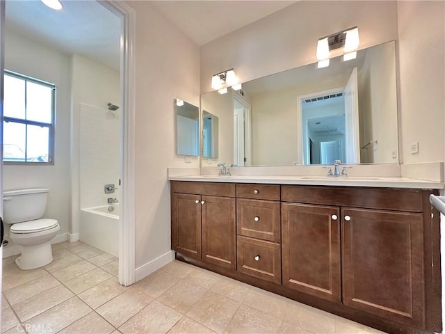 full bath with toilet, a sink, tile patterned flooring, double vanity, and baseboards