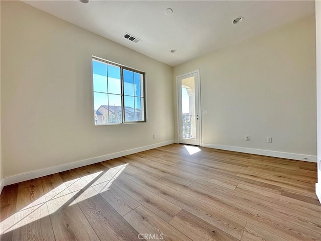 unfurnished room with visible vents, baseboards, and light wood finished floors