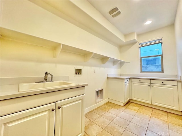 laundry room with visible vents, washer hookup, a sink, cabinet space, and light tile patterned floors