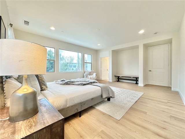 bedroom with recessed lighting, light wood-style floors, visible vents, and baseboards