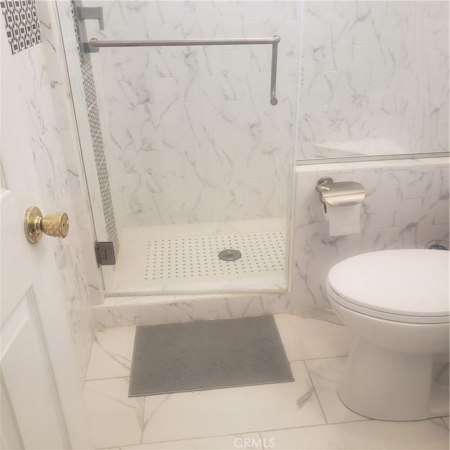 bathroom with a marble finish shower, toilet, and marble finish floor