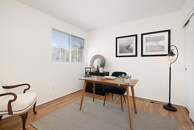 office area featuring baseboards and wood finished floors