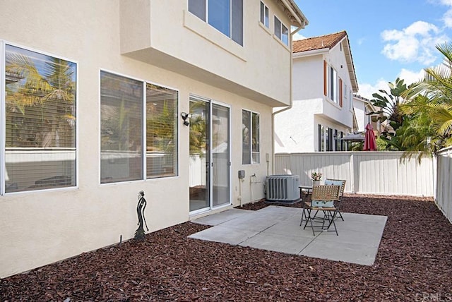 view of patio featuring central air condition unit and a fenced backyard