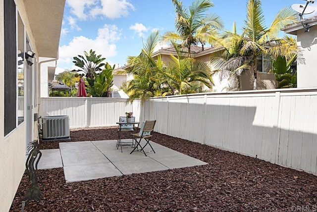 view of yard featuring central air condition unit, a fenced backyard, and a patio area