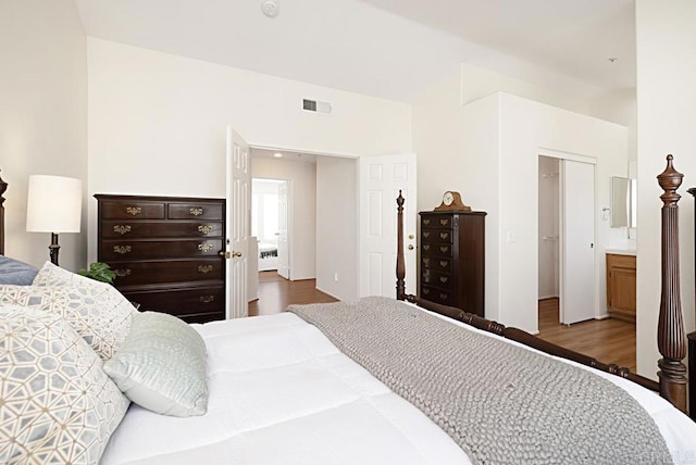 bedroom with visible vents and wood finished floors