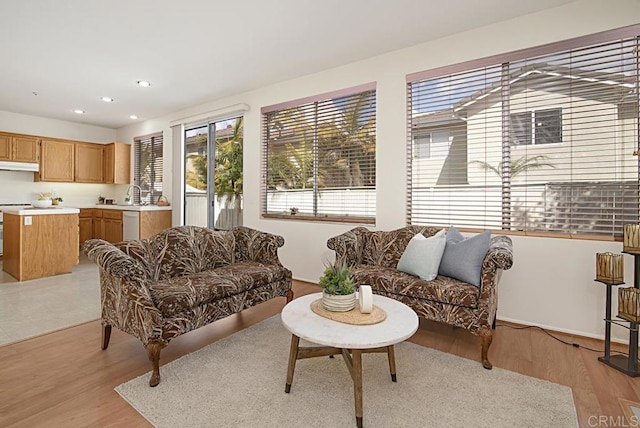 living area with recessed lighting and light wood-type flooring