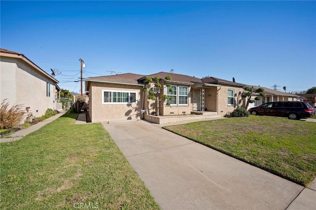 ranch-style house featuring stucco siding and a front yard