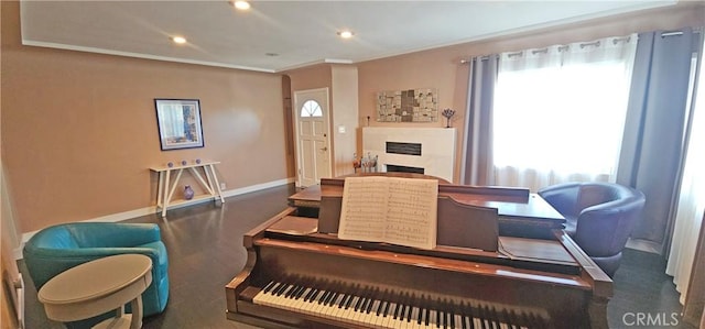 dining space featuring recessed lighting, a fireplace, baseboards, and ornamental molding